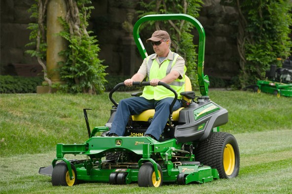Lawn Service Professional riding a John Deer commercial mower